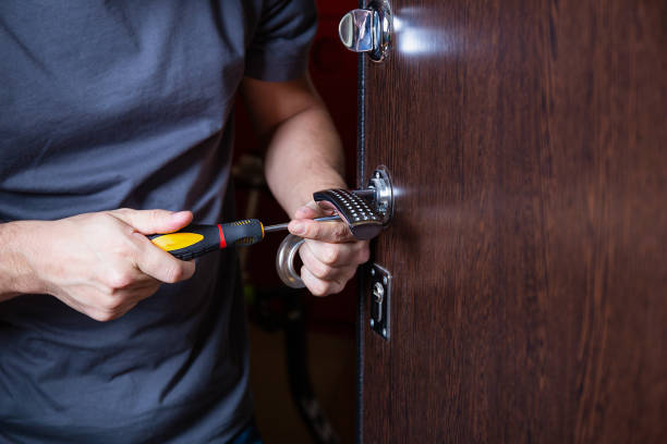 Locksmith replacing door lock to new after losing keys. Robbery protection, safety improvement. Close up hands of Repairman or workman changing or repair door lock by screwdriver